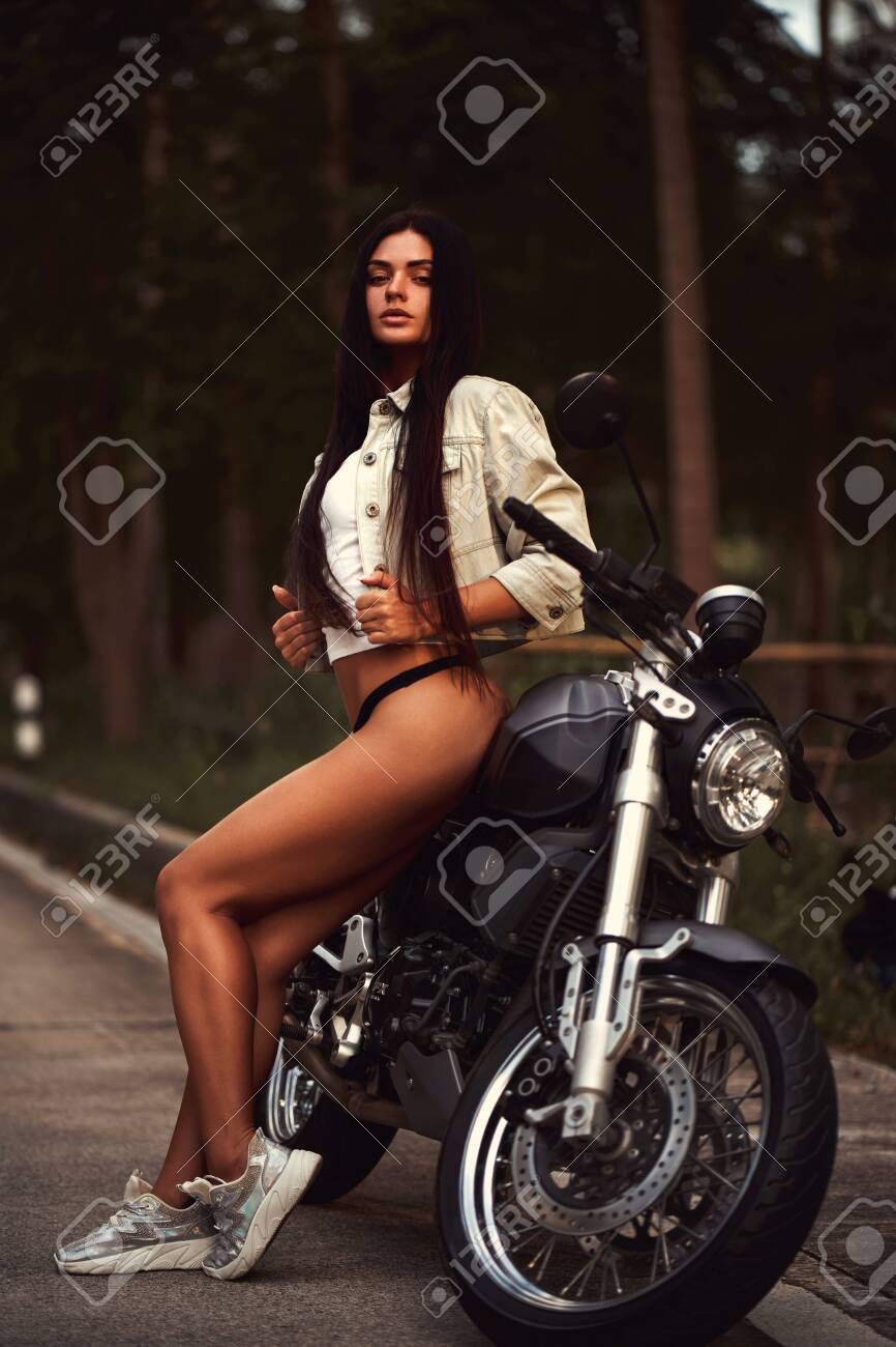 141621271-woman-with-a-black-motorcycle-in-cafe-racer-style.jpg